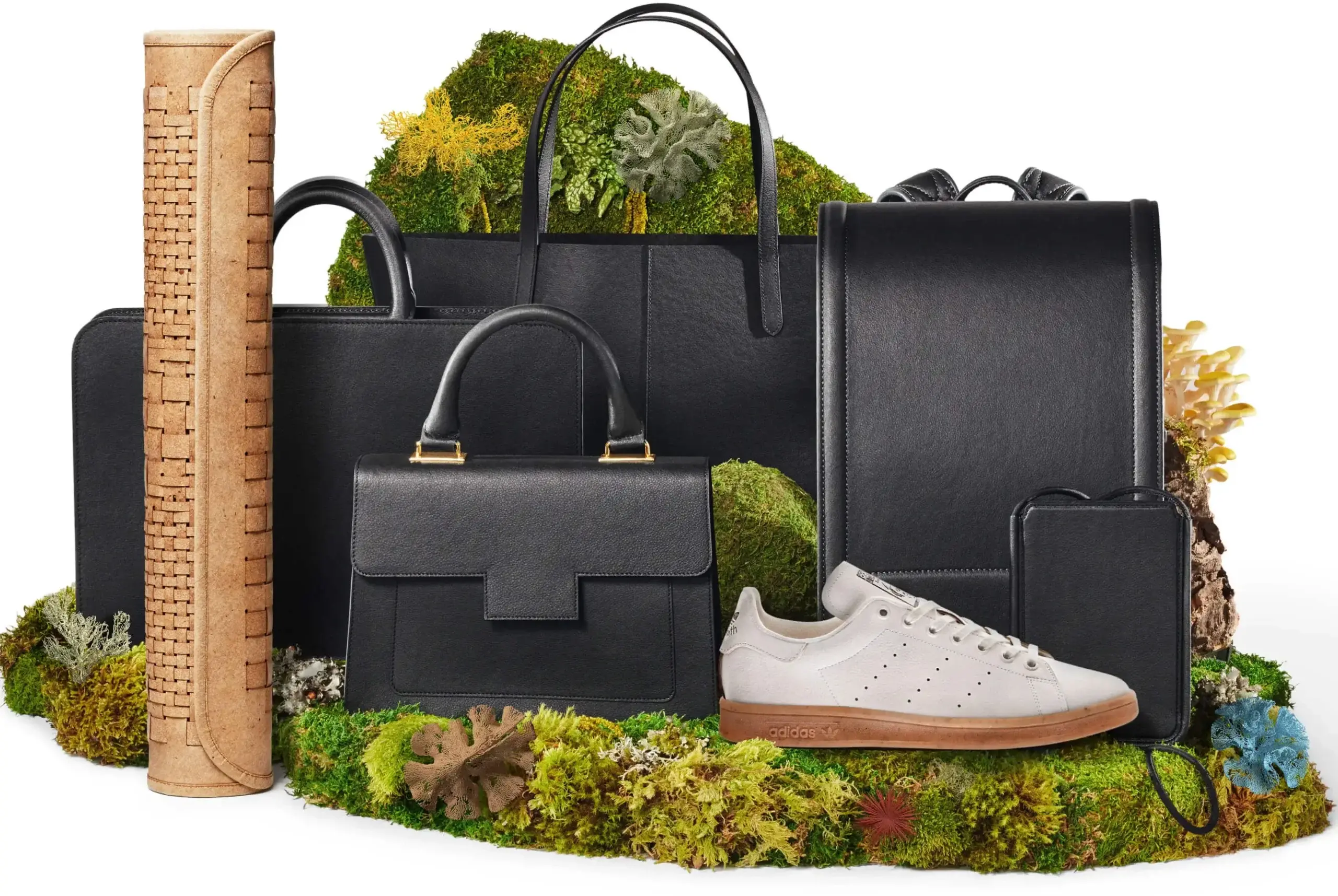Mylo leather alternative products arranged with moss and an Adidas sneaker